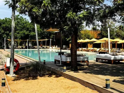 a swimming pool with tables and chairs and umbrellas at Les Jardin d'Atlas golf and Waky with private Pool in Marrakech