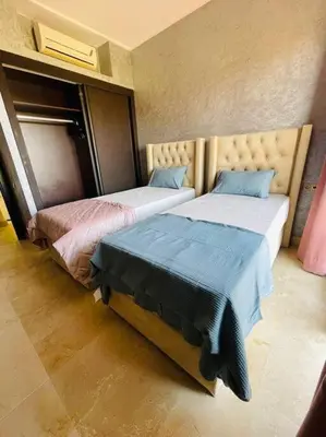 two beds sitting next to each other in a room at Les Jardin d'Atlas golf and Waky with private Pool in Marrakech