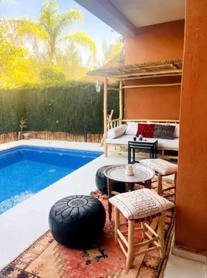 a patio with a pool and a table and chairs at Les Jardin d'Atlas golf and Waky with private Pool in Marrakech