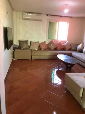 a living room with a couch and a table at La Paix Appart in Marrakech
