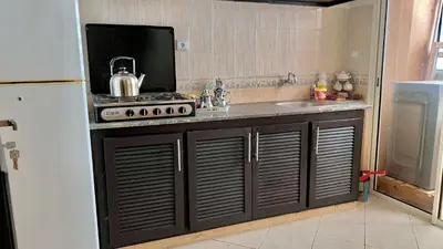 a kitchen with a stove and a sink at Excellent apparentement, in Marrakech