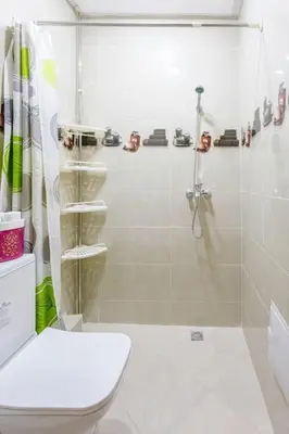 a white bathroom with a shower and a toilet at Guéliz Cosy apart 2 Bedrooms in Marrakech