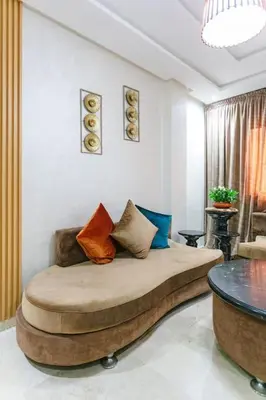 a living room with a bed with pillows on it at Guéliz Cosy apart 2 Bedrooms in Marrakech