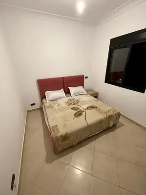 a bedroom with a bed and a flat screen tv at Resort med 24t sikkerhet og basseng - nærme Gueliz in Marrakech