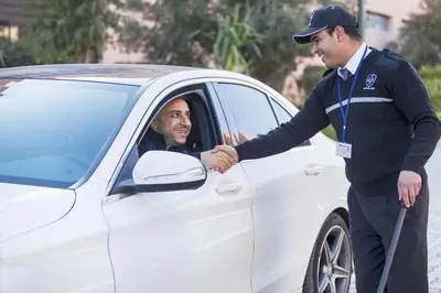 a man is getting out of a white car at Resort med 24t sikkerhet og basseng - nærme Gueliz in Marrakech