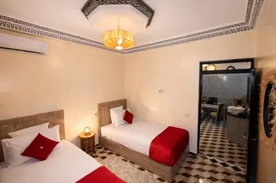 a hotel room with two beds and a bathroom at appartement au cœur du Madina in Marrakech