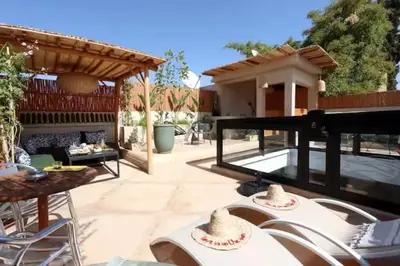 a patio with a table with hats on it at Riad Ptit Kech, Bassin terrasse - Petits déjeuners in Marrakech