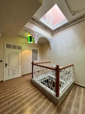 an attic room with a staircase and a skylight at Riad 052 in Marrakech