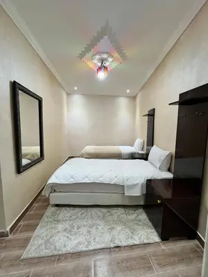 a bedroom with a large bed and a mirror at Riad 052 in Marrakech