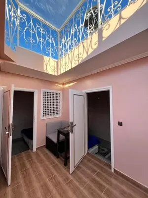 a room with a ceiling and a room with a table at Riad 052 in Marrakech
