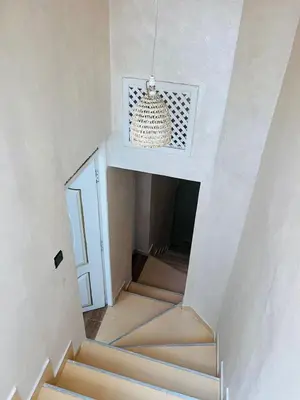 a staircase in a house with a chandelier at Riad 052 in Marrakech