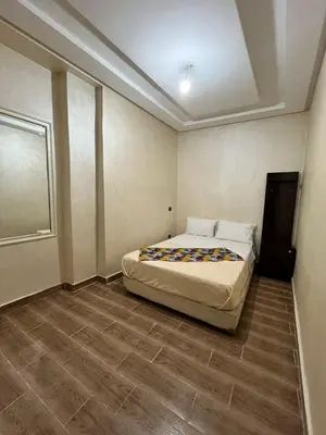 a bedroom with a bed in the corner of a room at Riad 052 in Marrakech