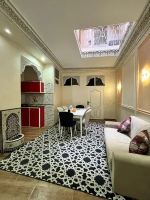 a living room with a table and a couch at Riad 052 in Marrakech