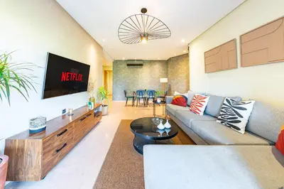 a living room with a couch and a tv at stylish appart with 3Bedrooms in Prestigia in Marrakech