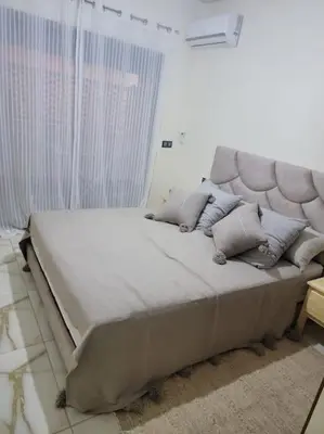 a bedroom with a large bed with pillows on it at Magnifique appartement luxueux à 10mn du centre in Marrakech