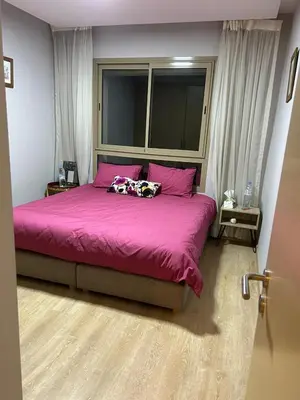 a bedroom with a large pink bed with two pillows at Luxury 2 bedroom flat Center Marrakesh in Marrakech