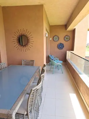 a dining room with a large blue table and chairs at Luxury 2 bedroom flat Center Marrakesh in Marrakech