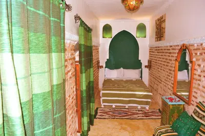 a bedroom with a bed in a room with a window at Riad marrakesh peace in Marrakech