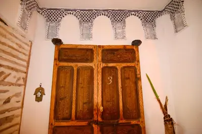 a room with a wooden door in a wall at Riad marrakesh peace in Marrakech