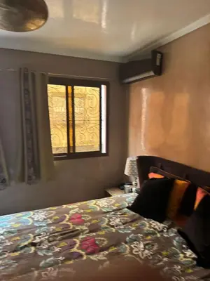 a bedroom with a bed and a window at riad didimora in Marrakech