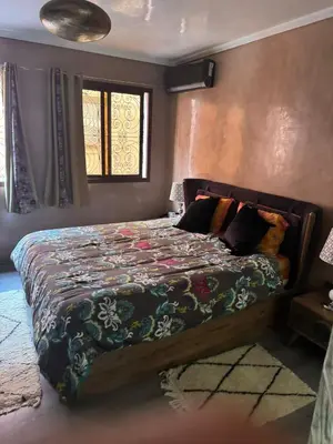 a bedroom with a bed with a quilt on it at riad didimora in Marrakech