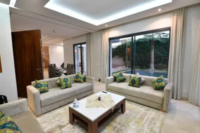 a living room with two couches and a coffee table at villa noria golf 4 chambres centre ville in Marrakech