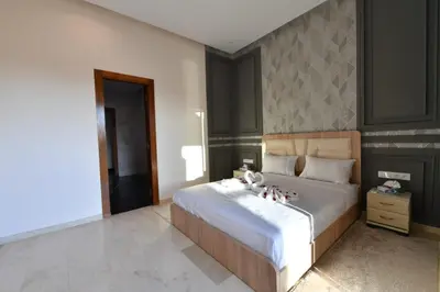 a bedroom with a bed with a teddy bear on it at villa noria golf 4 chambres centre ville in Marrakech