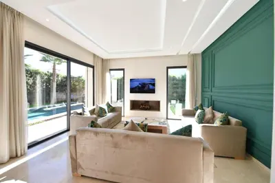 a living room with two couches and a fireplace at villa noria golf 4 chambres centre ville in Marrakech