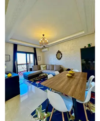 a living room with a table and a couch at Hosted by Zakia in Marrakech