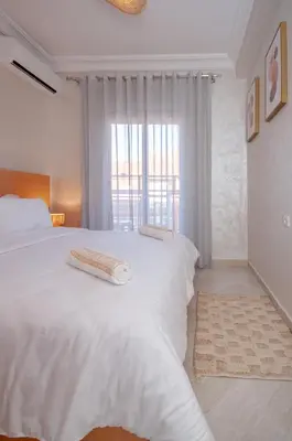a bedroom with a white bed with two towels on it at New elegant apartment with 2 bedroom in Marrakech