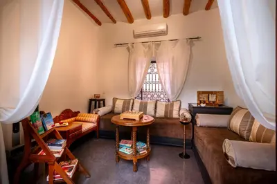 a living room with a couch and a table at Riad Dar Haris in Marrakech