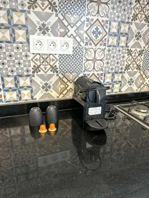 a room with a table with a toaster on a wall at Lyana Home in Marrakech
