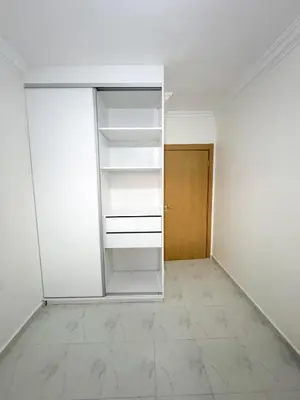 an empty room with white shelves and a door at Lyana Home in Marrakech