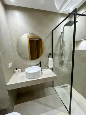 a bathroom with a sink and a mirror at Lyana Home in Marrakech