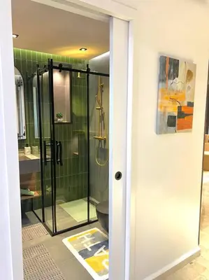 a bathroom with a glass shower and a toilet at Appartement Marrakech Hivernage N4 RESIDENCE CAPRICE PALACE in Marrakech