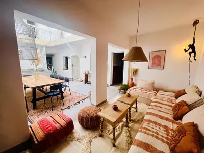 a living room with a couch and a table at Votre riad privé en médina avec services inclus in Marrakech