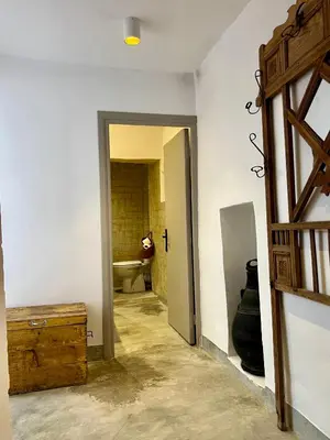 a hallway with a room with a sink and a door at Votre riad privé en médina avec services inclus in Marrakech