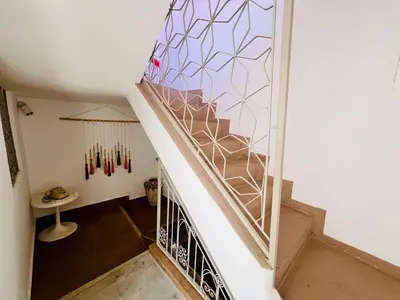 a staircase with a stained glass window in a house at Votre riad privé en médina avec services inclus in Marrakech