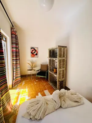 a living room with a bed in a room at Votre riad privé en médina avec services inclus in Marrakech