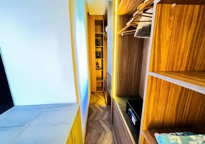 a small closet with wooden cabinets and a room with at Villa de luxe, Piscine chauffée, Petit Déjeuner, Hammam, Ménage, Proche centre de Marrakech in Marrakech