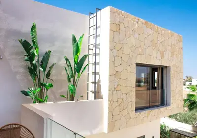 a facade of a building with a window and plants at Villa de luxe, Piscine chauffée, Petit Déjeuner, Hammam, Ménage, Proche centre de Marrakech in Marrakech