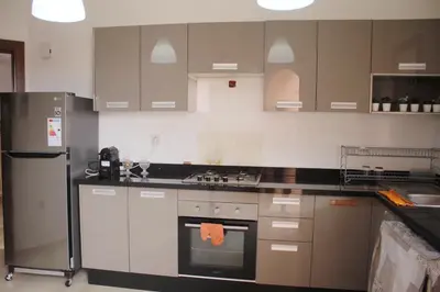 a kitchen with stainless steel appliances and gray cabinets at Premium Stay in Marrakech