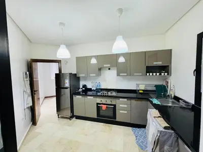 a kitchen with a black refrigerator and a sink at Premium Stay in Marrakech