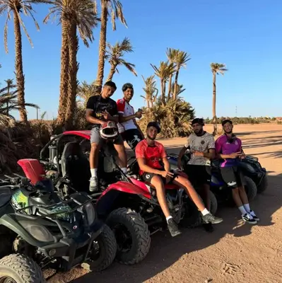 a group of people sitting on atvs in the desert at Premium Stay in Marrakech