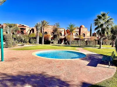 a swimming pool in front of a house at Garden Villa-Style Retreat with Patio, BBQ & Pools in Marrakech