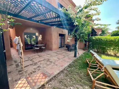 a patio with a pergola and a table and chairs at Garden Villa-Style Retreat with Patio, BBQ & Pools in Marrakech