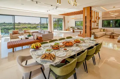 a dining room with a table with food on it at Villa Talia, Luxury Stay, Golf & Lake View in Marrakech