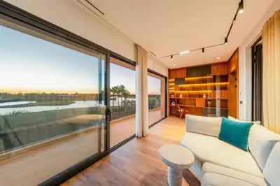 a living room with a couch and large windows at Villa Talia, Luxury Stay, Golf & Lake View in Marrakech
