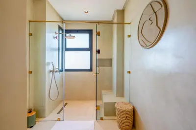 a bathroom with a shower and a glass door at Villa Talia, Luxury Stay, Golf & Lake View in Marrakech