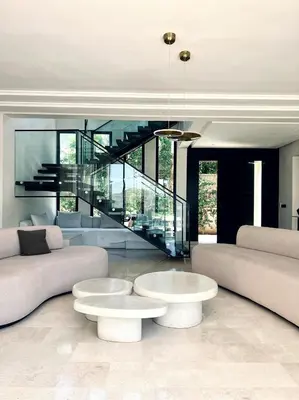a living room with two couches and a staircase at villa white in Marrakech